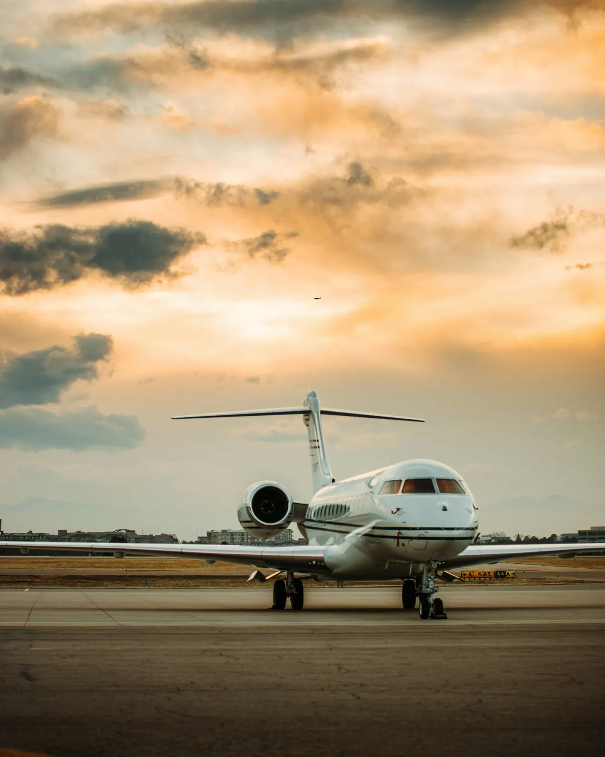Business jet on a desert-toned ramp at sunset