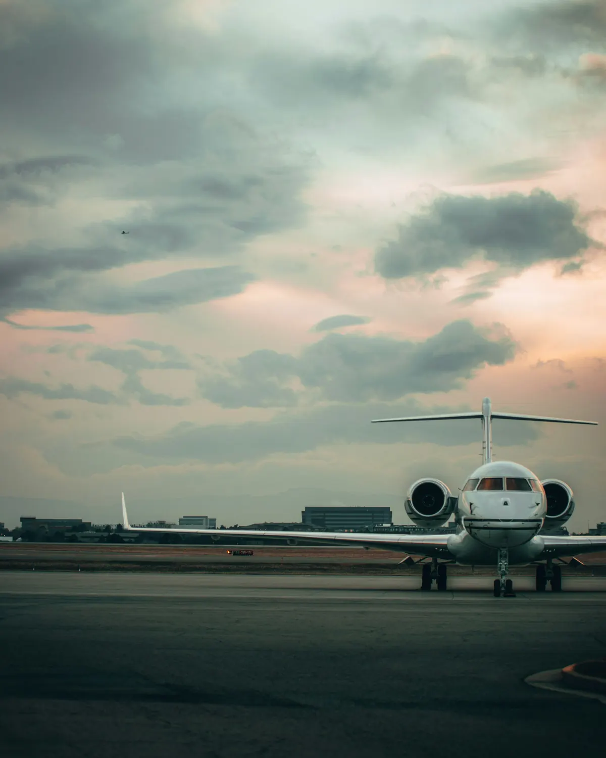 Business jet waiting on the ramp under an evening sky